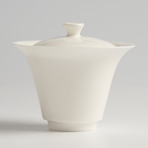 White ceramic teapot on a light gray background