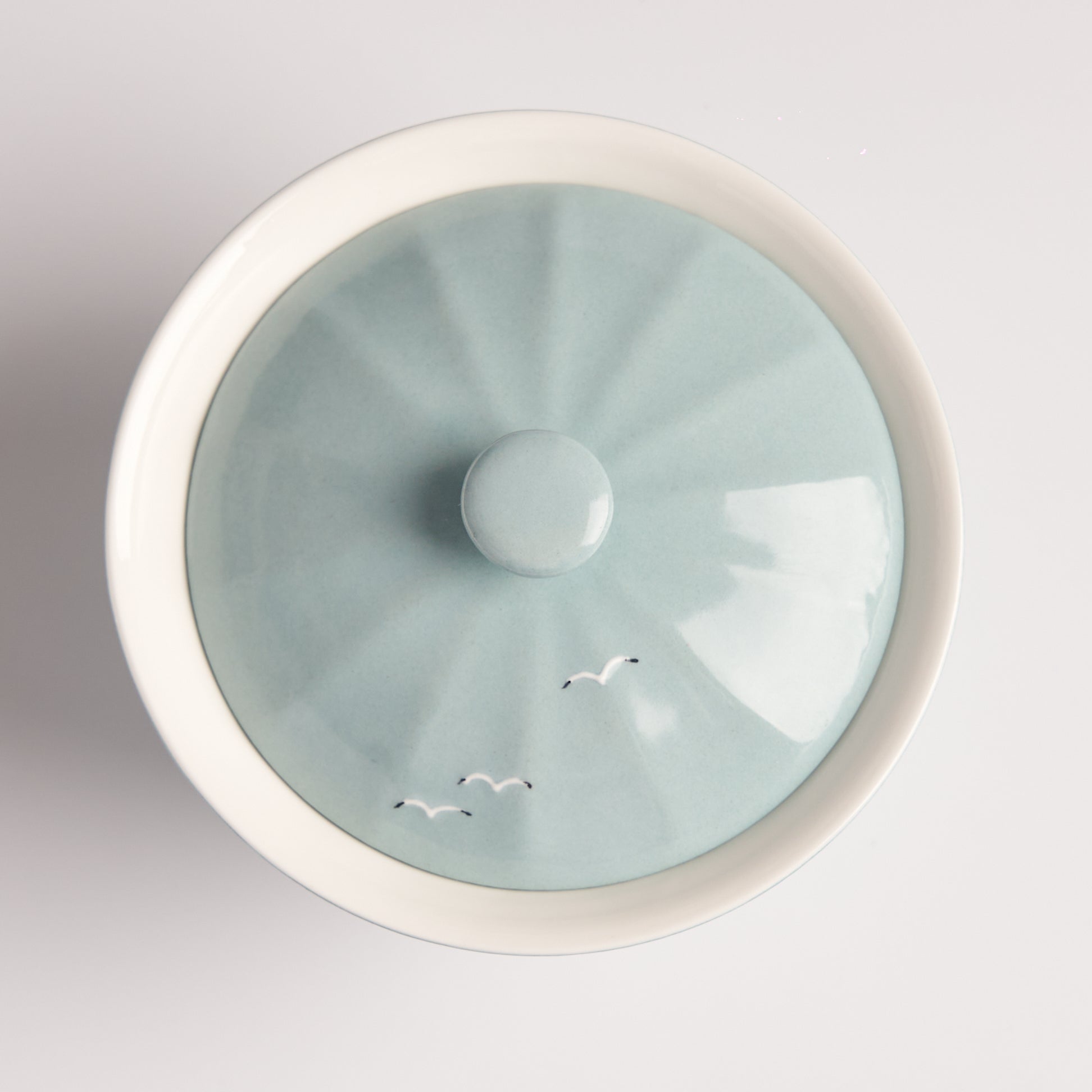 Top view of Story Blue Gaiwan lid with soft blue glaze and minimalist artwork