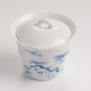 Top view of white porcelain gaiwan lid with smooth glaze and curved handle