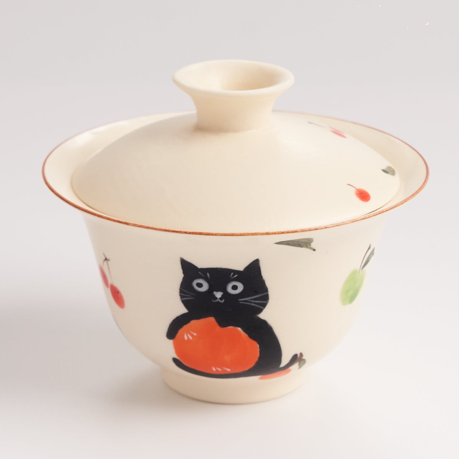 Ceramic cup with a black cat design on a white background