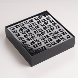 Modern black acrylic tea tray featuring precision cutout pattern