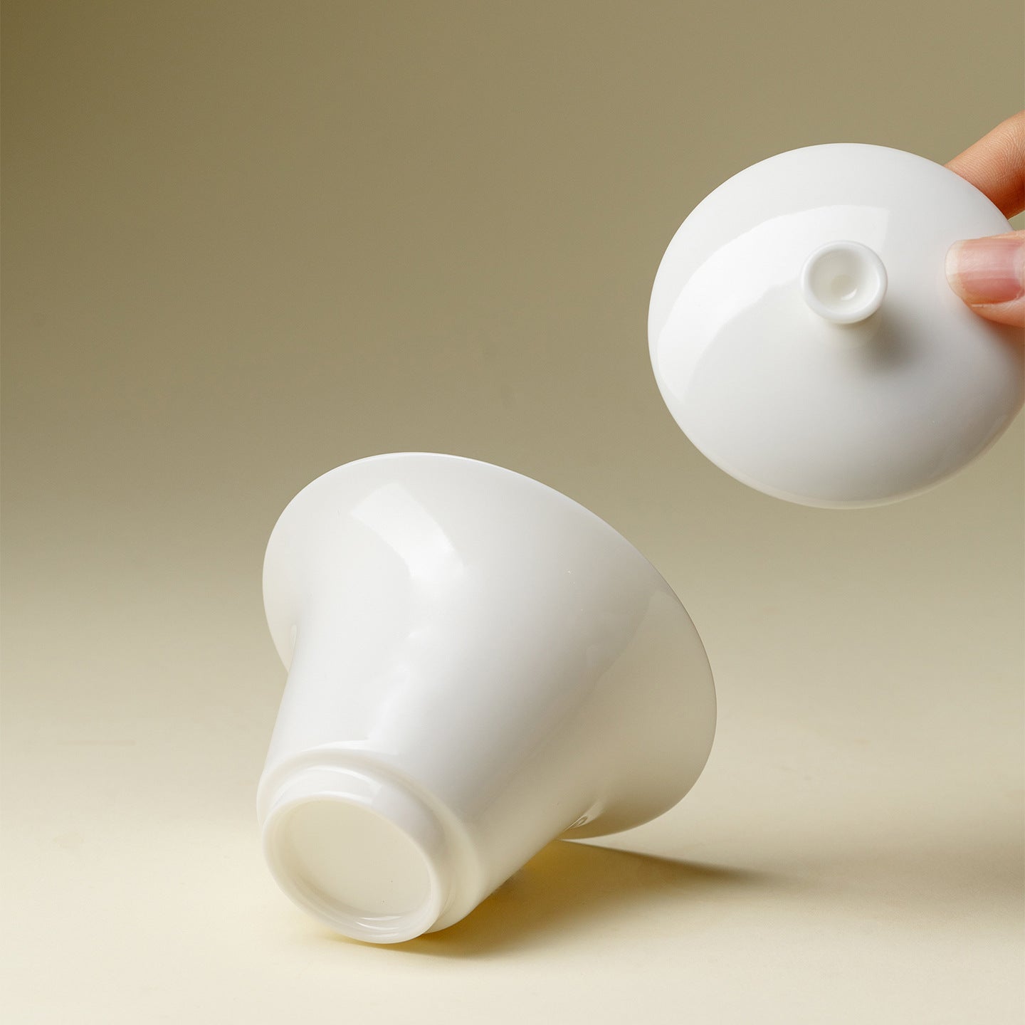 White ceramic cups with lids on a beige background