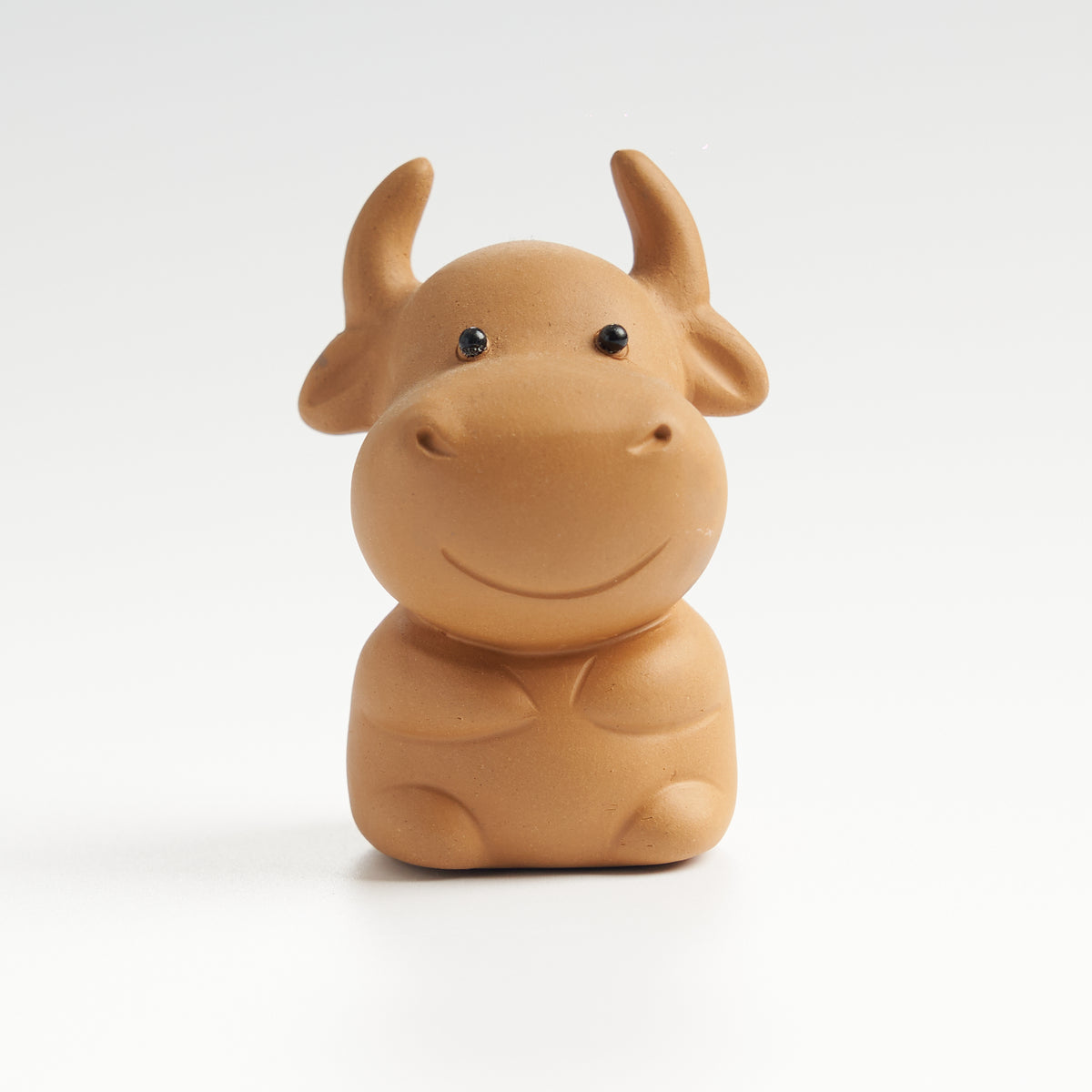 Cute sculpted ox tea pet, front eye-level view