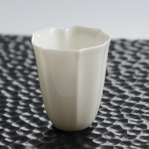 Faceted White Porcelain Tea Cup — styled tea setting