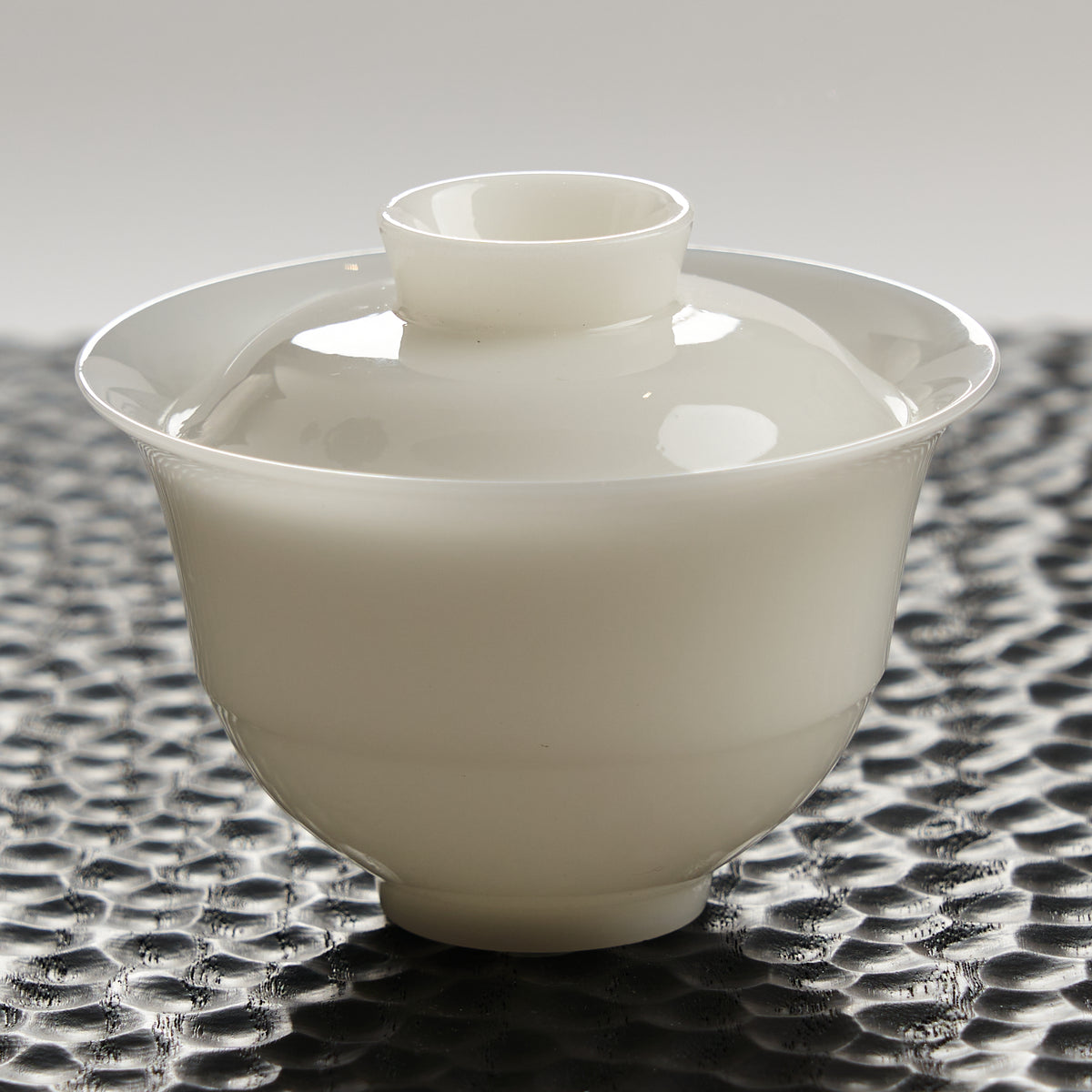 Ice Jade Porcelain Gaiwan — rounded 110 ml style on a dark textured tea tray