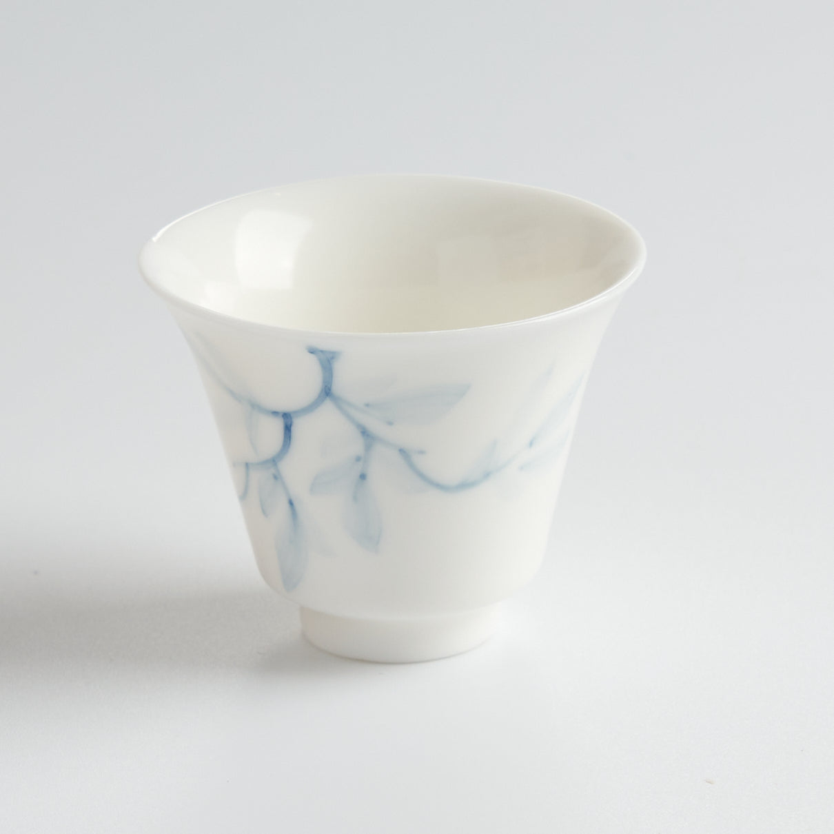 Blue-and-White Porcelain Hand-Painted Magnolia Tasting Cup — angled view