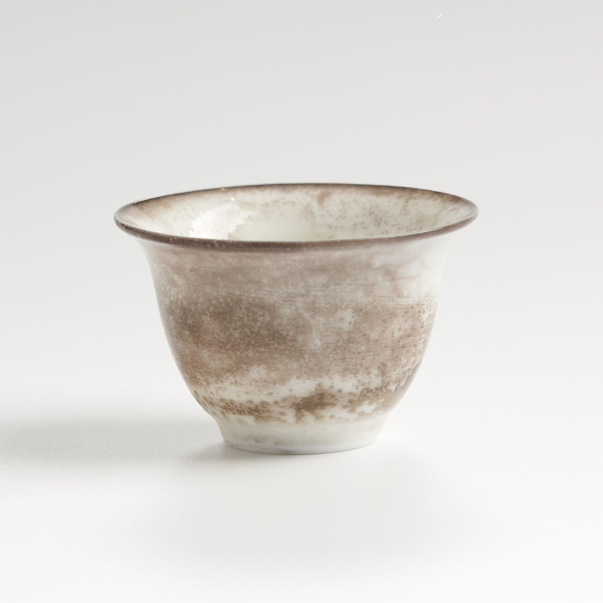 Rustic speckled stoneware teacup set, single cup front view