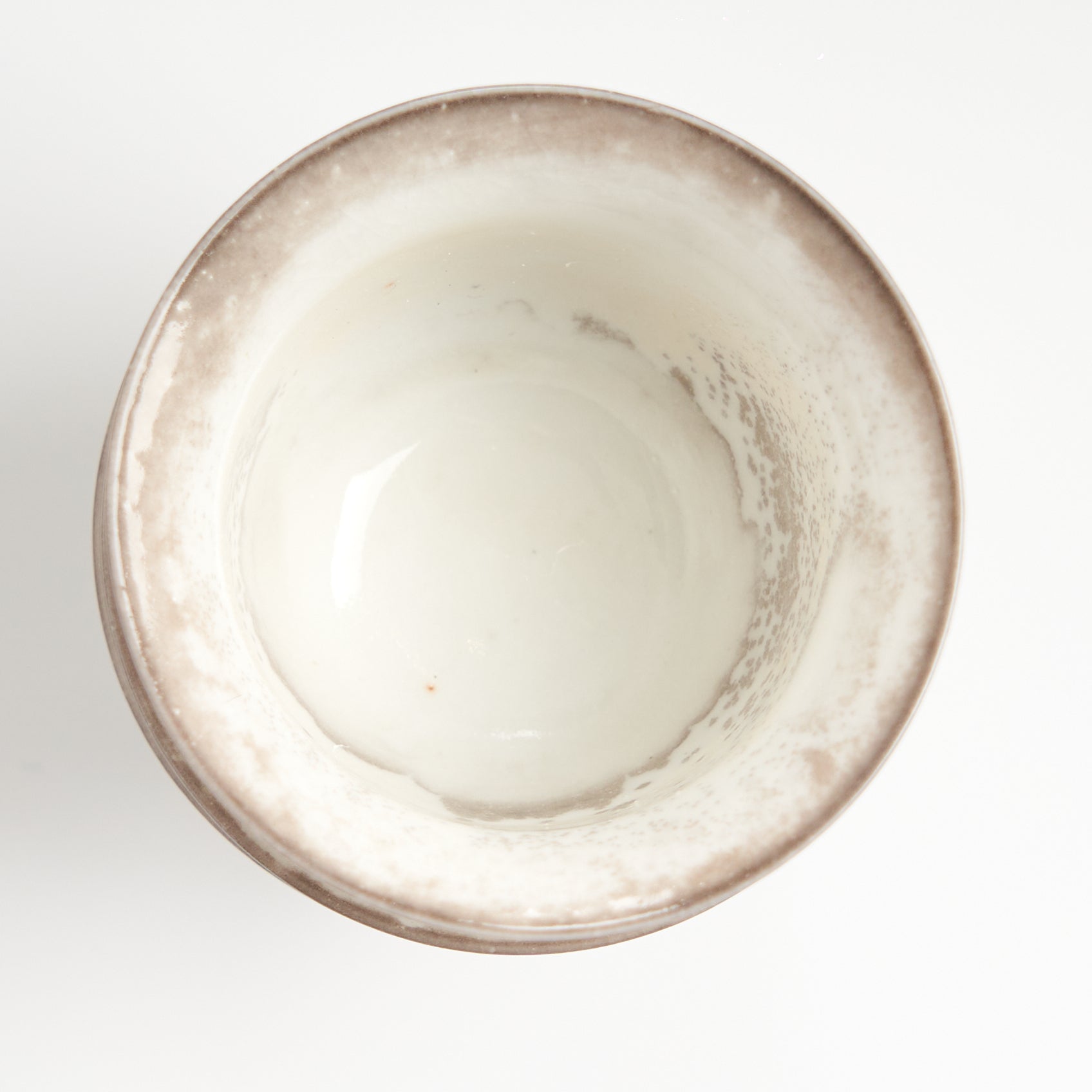 Rustic speckled stoneware teacup set, top-down glaze detail