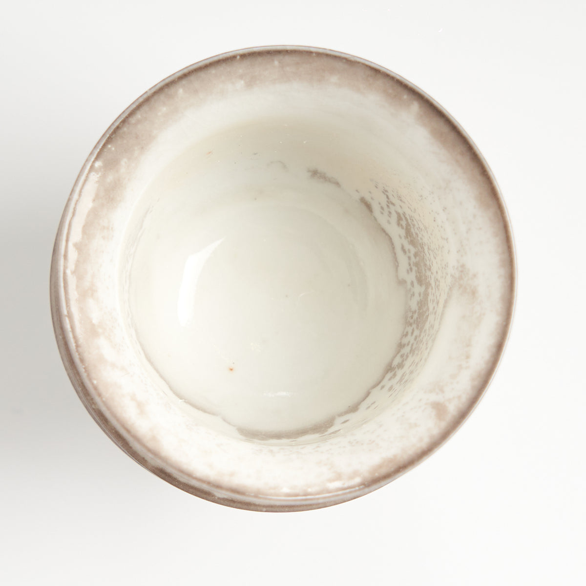 Rustic speckled stoneware teacup set, top-down glaze detail