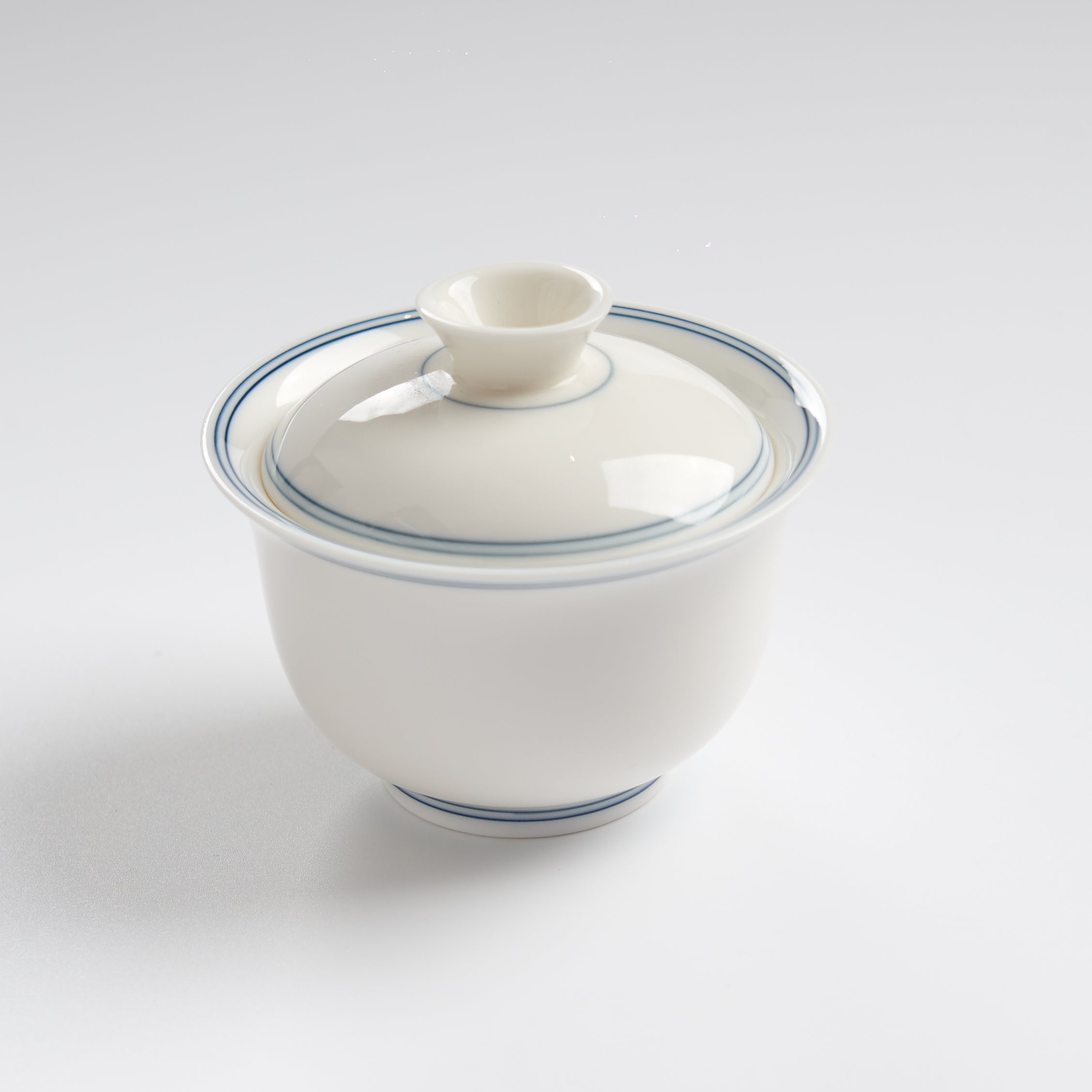 Sheep-fat white porcelain blue-rim evaluation gaiwan, slightly overhead wide view