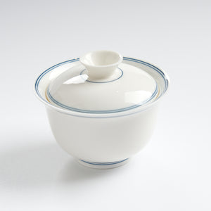 Sheep-fat white porcelain blue-rim evaluation gaiwan, three-quarter overhead view
